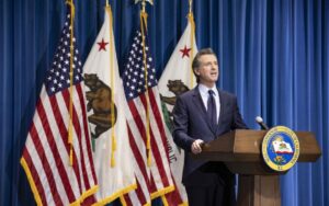 Gavin Newsom 2021 81df12c63cb45f070471ae6e156aa83737141e75c8ee77bf938057e312b53495 Gov Newsome Announces 2021 Budget