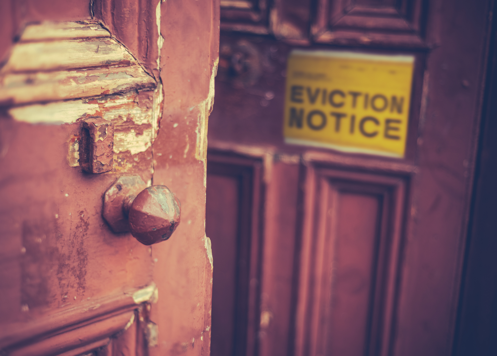 Grungy Old Door With A Yellow Eviction Notice